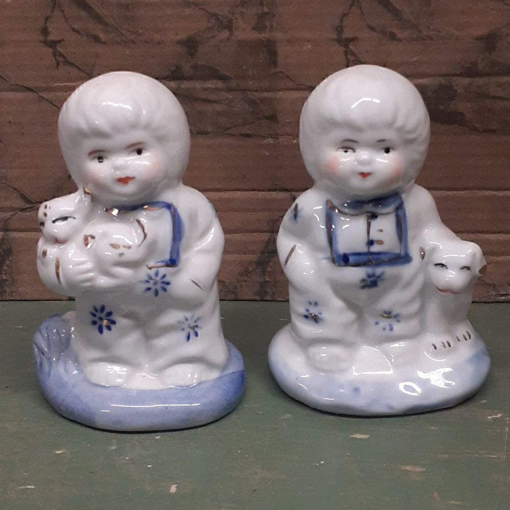 Pair of porcelain oriental figures white with blue and gold trim